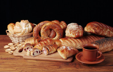 Bakery products. Rolls, loaves, loaves, pies on a dark background