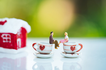Miniature of a women and a man in love on coffee cup with bokeh light copyspace, couple in love and pre-wedding background concept