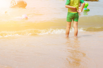 Girl standing on beach.