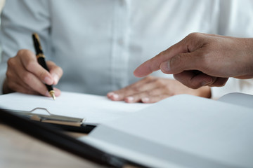 Legal counsel presents to the client a signed contract with gavel and legal law. justice and lawyer concept.