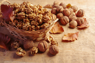 Walnut kernels in a wicker basket on a wooden table. Close-up