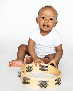 Baby Sitting On The Floor With A Tambourine