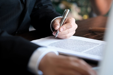 Legal counsel presents to the client a signed contract with gavel and legal law. justice and lawyer...