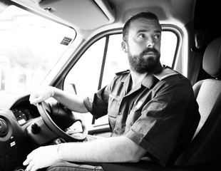 Male paramedic driving an ambulance