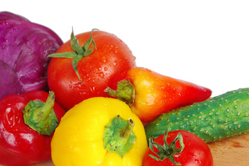 Red tomatoes cut and vegetables on a white background. Copy space.