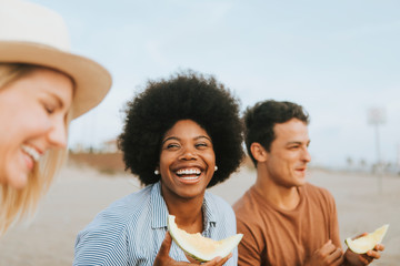 Diverse friends enjoying their beach picnic