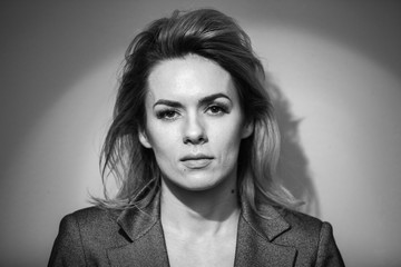 Dramatic black and white portrait of a beautiful woman on a dark background