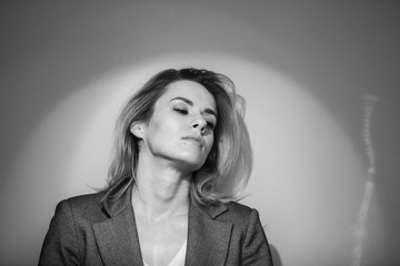 Dramatic black and white portrait of a beautiful woman on a dark background