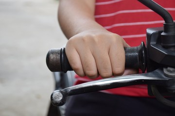 People hand holds a motorcycle throttle control for going to somewhere.