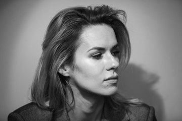 Fototapeta premium Dramatic black and white portrait of a beautiful woman on a dark background