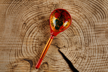 A wooden spoon painted in Khokhloma style - a traditional ancient Russian handicraft.