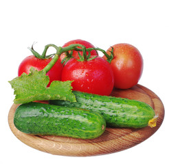 Vegetables on a white background. Tomatoes and cucumbers