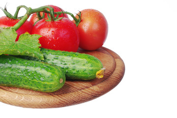 Vegetables on a white background. Tomatoes and cucumbers