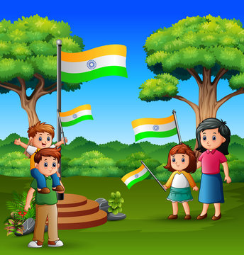 Happy family holding national flag on the nature