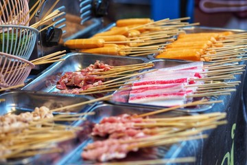 Raw meat beef pork chicken Sausage in wooden stick - street food.