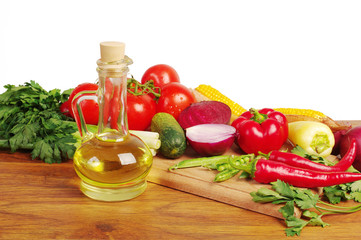 Vegetables and a bottle of sunflower oil. Pepper, tomato, cucumber, onion