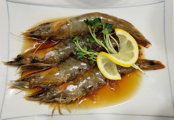 Shrimp with lemon on white plate