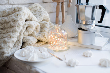 Cozy winter interior styling and decor, warm string lights in bell jar