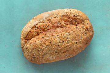 Whole loaf bread crisp stone background top view