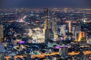 Fototapeta premium Cityscape of illuminated building with department store near Chao Phraya river