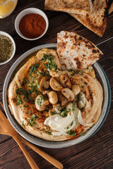 Traditional Mediterranean hummus with mushrooms and onions. Classic Hummus with paprika, olive oil, onions, mushrooms and seasonings