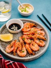 Shrimp glazed in soy sauce with green onion and lemon.