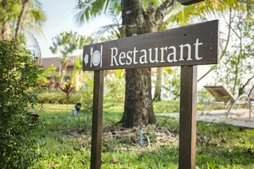 Wooden board sign Restaurant in the garden.