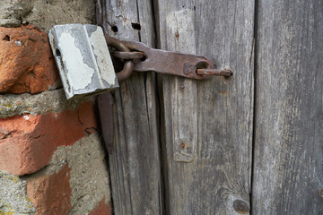 Old padlock on a wooden door
