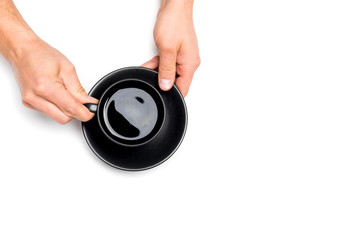 men's hands holding a black cup of coffee on white isolated background, place for text