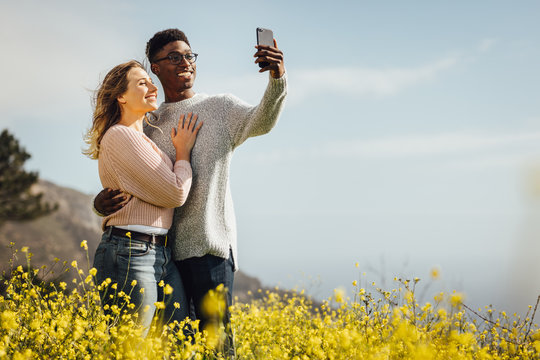 Loving young couple talking selfie