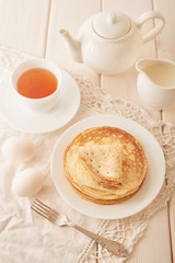 Healthy summer breakfast, homemade classic american pancakes with honey,cozy morning, copy space. Pancakes, teapot, honey on white wooden table. Pancake week. russian traditional holiday Maslenitsa