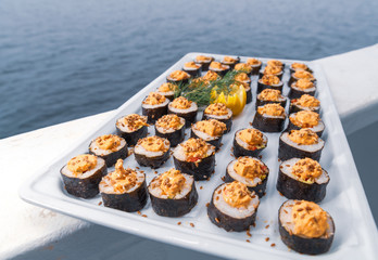 Sushi maki and a blue ocean