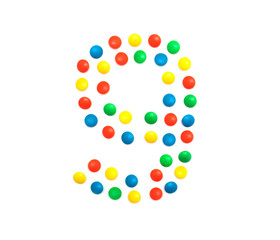 Children's numbers laid out from a multi-colored mosaic figure number 9, alphabet