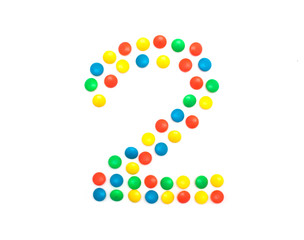 Children's numbers laid out from a multi-colored mosaic figure number 2, alphabet