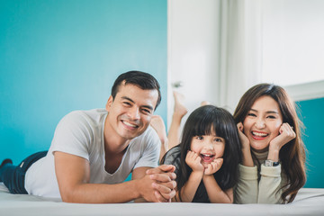 Portrait happy Asian family over blue background