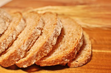 Close up of cereal healthy homemade bread slices on wooden table background. Side view