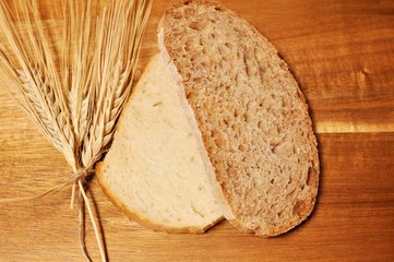 Top table of two slice, one brawn cereal healthy bread and another white, with dried wheat decoration on wooden table background