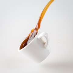 coffee splashing out of a cup isolated on white
