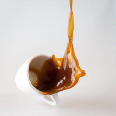 coffee splashing out of a cup isolated on white