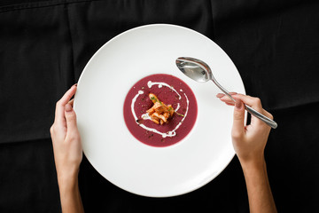 Top view of red cream soup with squid dish