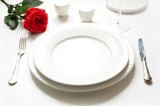 Valentine's day or birthday romantic dinner. Romantic table setting with red rose.