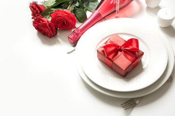 Valentine's day or birthday dinner. Elegance table setting with champagne and red rose.