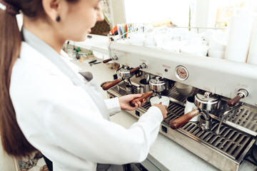 Close up of female barista preparing coffee