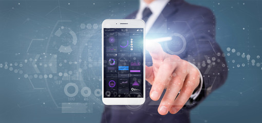 Businessman holding Smartphone with user interface data on the screen isolated on a background
