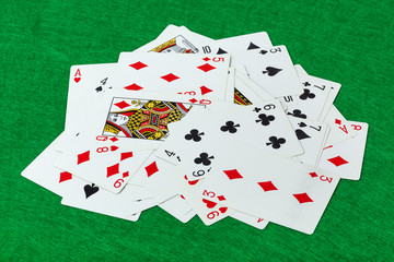 Casino playing cards on green table