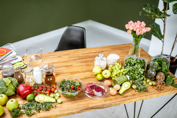 Nutritionists working place with variety of healthy raw food on the table in the green office