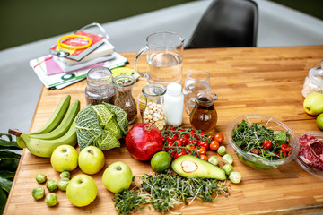 Nutritionists working place with variety of healthy raw food on the table in the green office