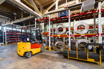 Tiered rack with sheet metal rolls. Internal warehouse of raw materials