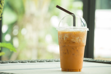 Glass of cold tea on the table, blurred background