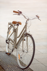 Fototapeta na wymiar Retro beige bicycle parked outdoors in Europe